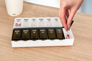 Amazon Basic Care pill organizer with AM and PM slots in blue and white